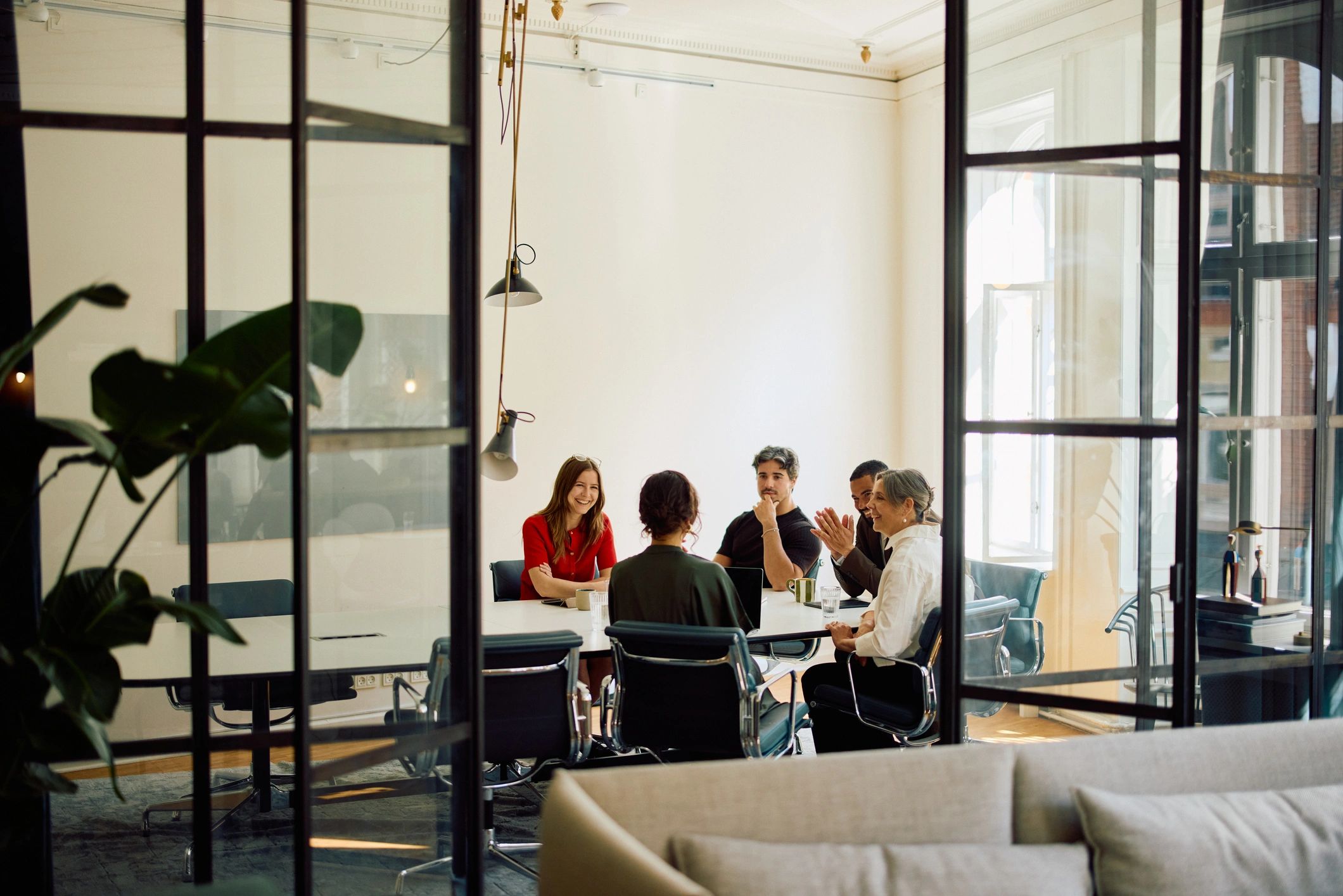 Professional team collaborating at a meeting table in a modern office